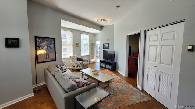 living room with baseboards and wood finished floors