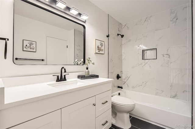 full bathroom with toilet, vanity, tile patterned floors, and tiled shower / bath combo