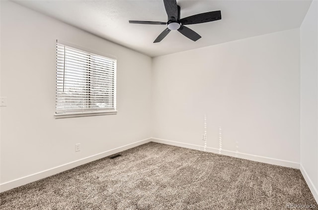 carpeted spare room featuring ceiling fan