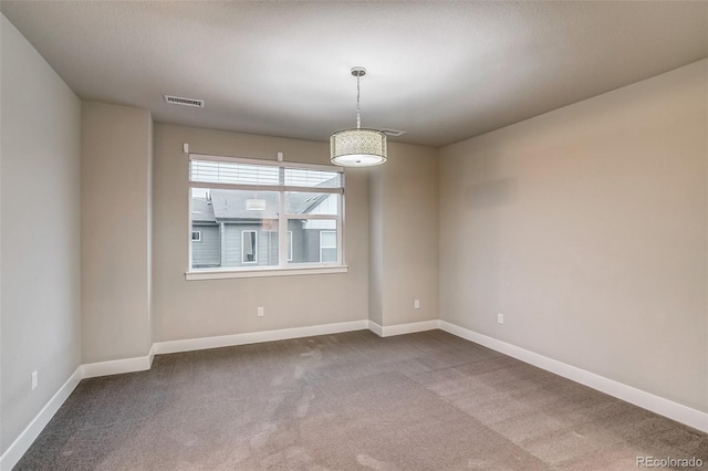 5185 Vivian St, Wheat Ridge, CO 80033 - empty room featuring dark colored carpet and baseboards