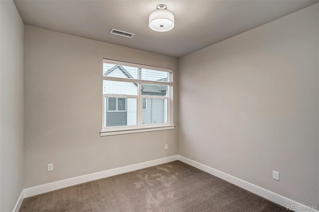 5185 Vivian St, Wheat Ridge, CO 80033 - spare room featuring baseboards and dark carpet