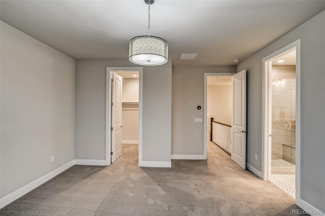 5185 Vivian St, Wheat Ridge, CO 80033 - unfurnished bedroom featuring carpet flooring, a walk in closet, baseboards, and connected bathroom