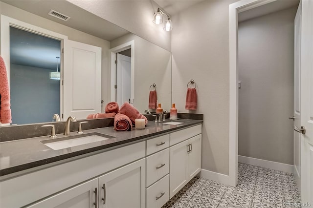5185 Vivian St, Wheat Ridge, CO 80033 - bathroom with double vanity, baseboards, and tile patterned floors