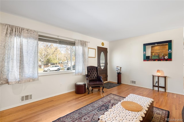 living area with hardwood / wood-style floors