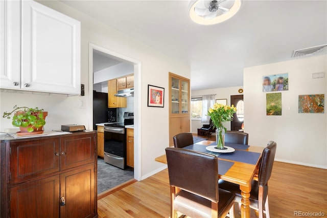 dining room featuring ceiling fan and light hardwood / wood-style floors