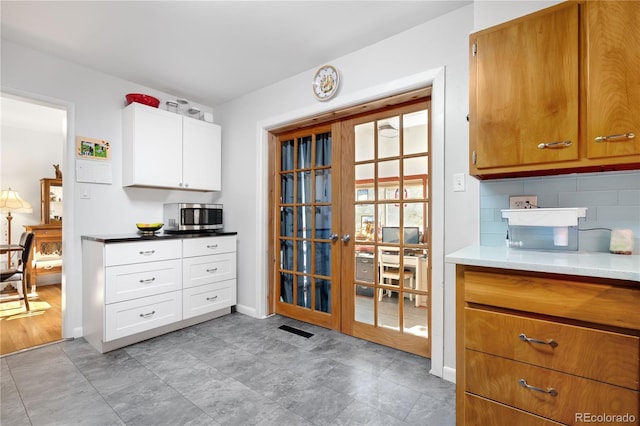 kitchen with white cabinets and decorative backsplash