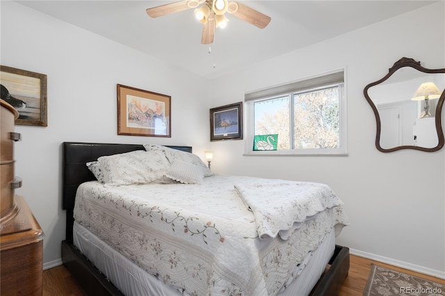 bedroom with ceiling fan and dark hardwood / wood-style floors