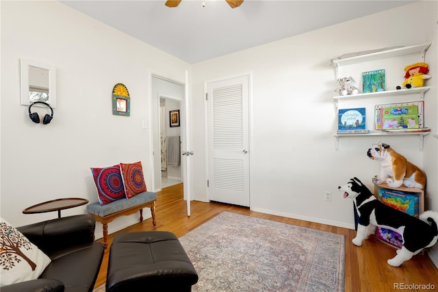 sitting room with ceiling fan and light hardwood / wood-style floors