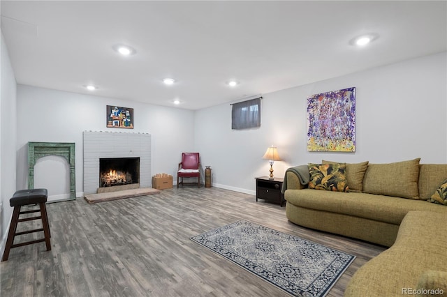 living room with hardwood / wood-style flooring and a fireplace