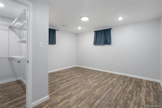 basement with dark hardwood / wood-style floors