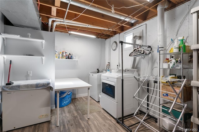 washroom featuring washing machine and clothes dryer and hardwood / wood-style flooring