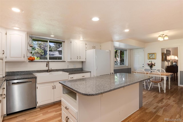 10366 E Ida Ave, Greenwood Village, CO 80111 - kitchen with stainless steel dishwasher, freestanding refrigerator, a sink, light wood-style floors, and plenty of natural light