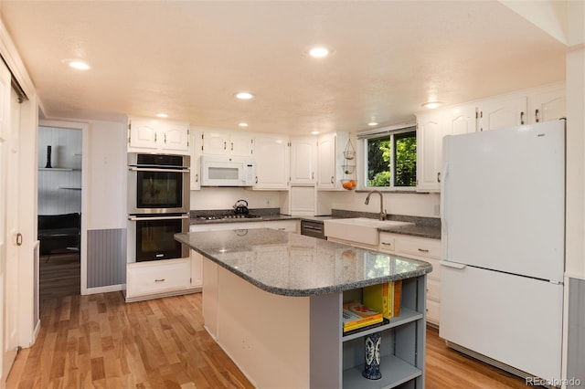 10366 E Ida Ave, Greenwood Village, CO 80111 - kitchen featuring stainless steel appliances, white cabinetry, a sink, open shelves, and dark stone countertops