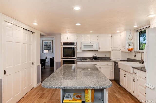 10366 E Ida Ave, Greenwood Village, CO 80111 - kitchen featuring stainless steel appliances, open shelves, white cabinetry, light wood-style flooring, and recessed lighting