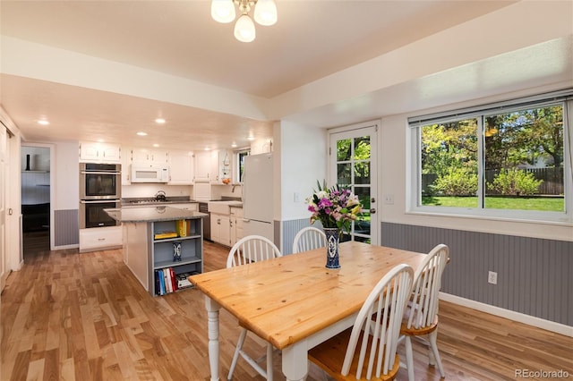 10366 E Ida Ave, Greenwood Village, CO 80111 - dining space with light wood-style flooring, recessed lighting, baseboards, and a wainscoted wall