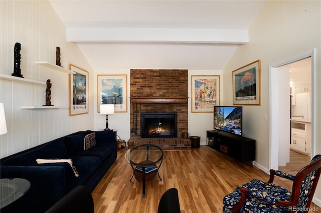10366 E Ida Ave, Greenwood Village, CO 80111 - living room featuring light wood-style flooring, a brick fireplace, and baseboards