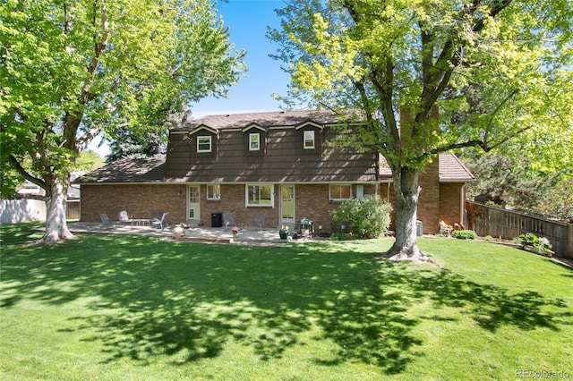 10366 E Ida Ave, Greenwood Village, CO 80111 - back of property with a patio, brick siding, a gambrel roof, and central AC