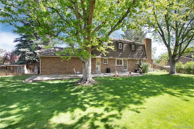 10366 E Ida Ave, Greenwood Village, CO 80111 - rear view of property with a patio area, a chimney, and brick siding