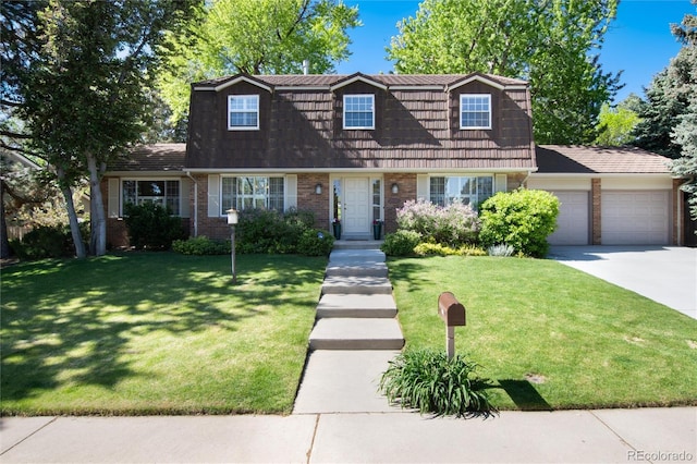 10366 E Ida Ave, Greenwood Village, CO 80111 - view of front facade featuring a garage, a front yard, brick siding, driveway, and a gambrel roof