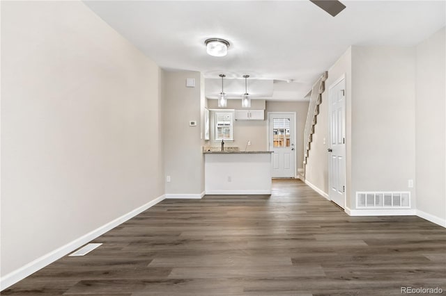 unfurnished living room with dark hardwood / wood-style floors