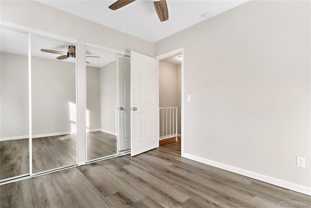 unfurnished bedroom with hardwood / wood-style floors and ceiling fan