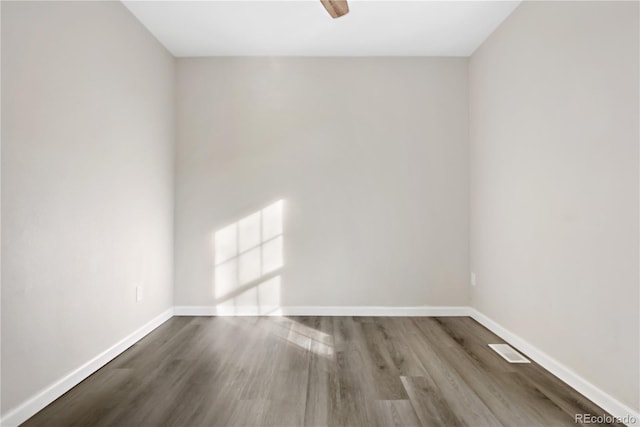 spare room featuring hardwood / wood-style floors and ceiling fan