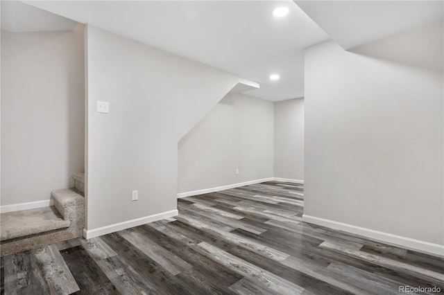 additional living space with dark hardwood / wood-style flooring