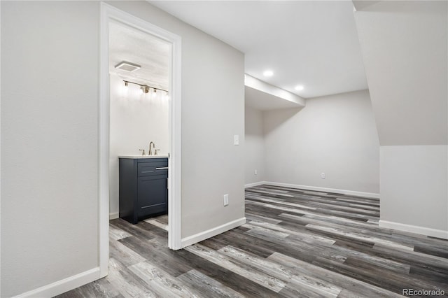 additional living space with dark hardwood / wood-style flooring and sink