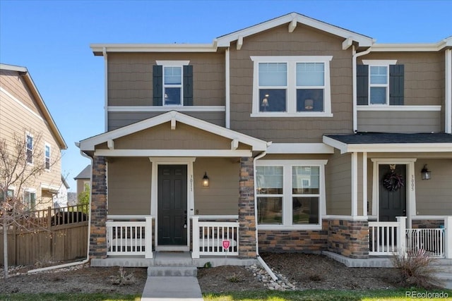 3011 Low Meadow Blvd, Castle Rock, CO 80109 - townhome / multi-family property featuring covered porch and stone siding
