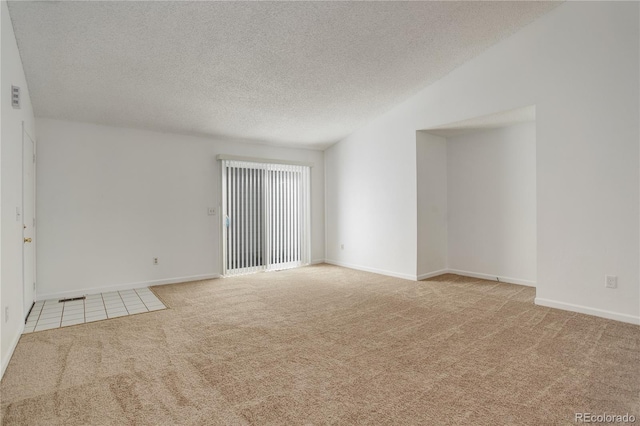 carpeted spare room with baseboards and a textured ceiling