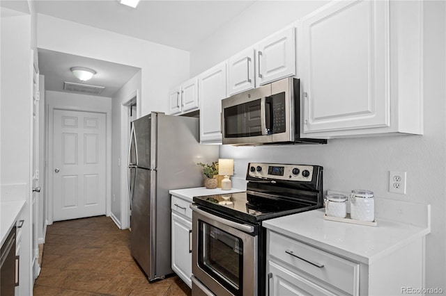 kitchen with white cabinets and appliances with stainless steel finishes