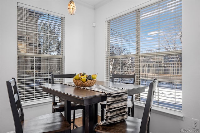 dining space with a wealth of natural light and ornamental molding