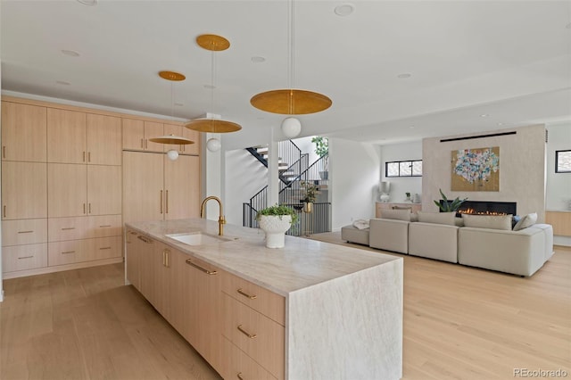 171 S Dexter St, Denver, CO 80246 - kitchen with light brown cabinets, light wood-type flooring, and modern cabinets