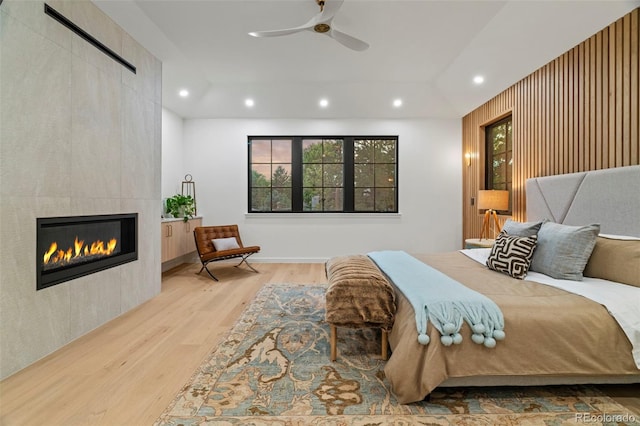 171 S Dexter St, Denver, CO 80246 - bedroom with wood finished floors, recessed lighting, a tile fireplace, and a ceiling fan