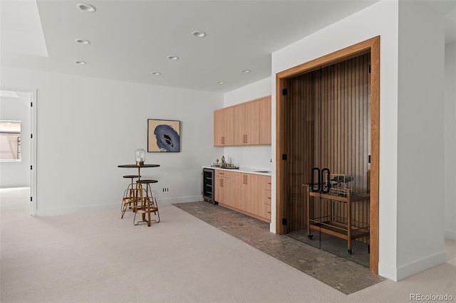171 S Dexter St, Denver, CO 80246 - kitchen featuring beverage cooler, light brown cabinets, recessed lighting, light colored carpet, and light countertops