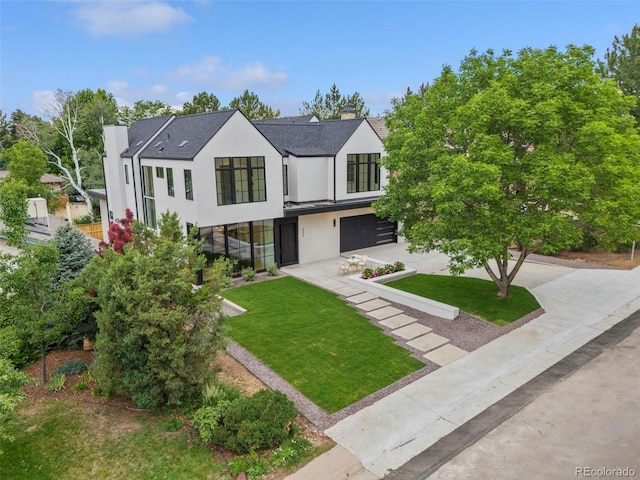 171 S Dexter St, Denver, CO 80246 - modern inspired farmhouse with stucco siding, a front yard, an attached garage, concrete driveway, and a chimney