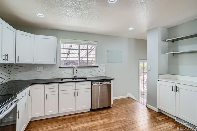 kitchen featuring dishwasher, white cabinets, a healthy amount of sunlight, and sink