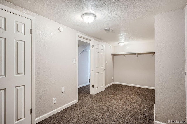 spacious closet with dark carpet