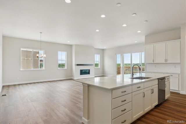 4978 Hickory Oaks St, Castle Rock, CO 80104 - kitchen with a sink, dishwasher, dark wood-type flooring, light countertops, and white cabinets
