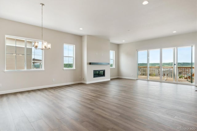 4978 Hickory Oaks St, Castle Rock, CO 80104 - unfurnished living room with healthy amount of natural light, wood finished floors, recessed lighting, and a chandelier