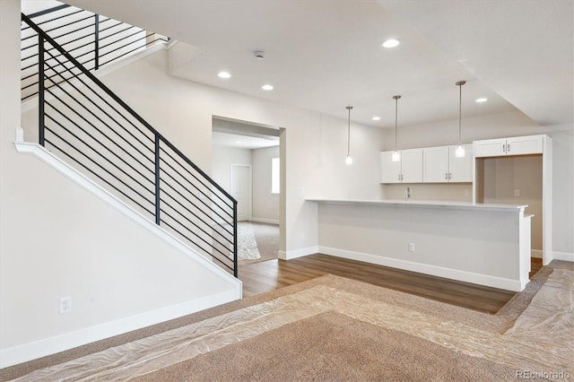 4978 Hickory Oaks St, Castle Rock, CO 80104 - kitchen with recessed lighting, wood finished floors, hanging light fixtures, white cabinetry, and light countertops