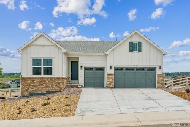 4978 Hickory Oaks St, Castle Rock, CO 80104 - view of front facade featuring board and batten siding, brick siding, concrete driveway, and a garage
