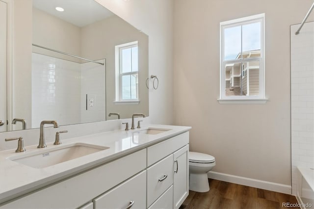 4978 Hickory Oaks St, Castle Rock, CO 80104 - full bathroom with toilet, double vanity, baseboards, wood finished floors, and shower / bathtub combination