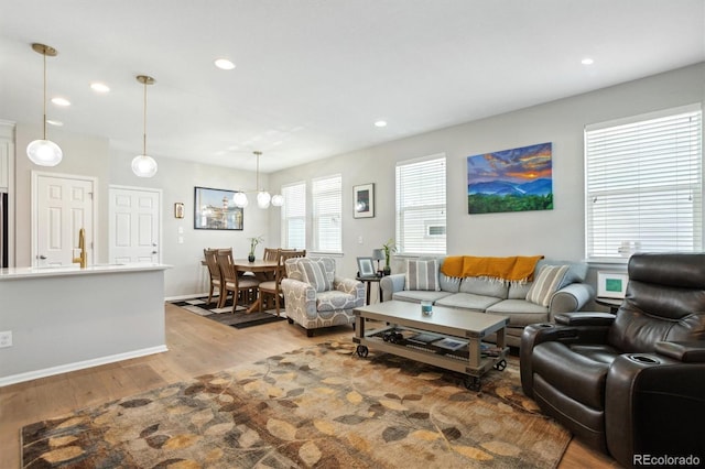 3178 Geneva Ct, Denver, CO 80238 - living area featuring wood finished floors, recessed lighting, a chandelier, and baseboards