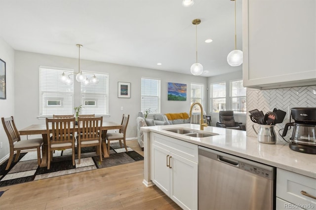 3178 Geneva Ct, Denver, CO 80238 - kitchen with dishwasher, a sink, light wood finished floors, white cabinetry, and tasteful backsplash