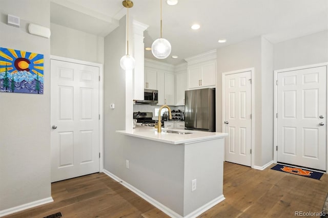 3178 Geneva Ct, Denver, CO 80238 - kitchen featuring stainless steel appliances, a peninsula, white cabinets, dark wood-style floors, and recessed lighting