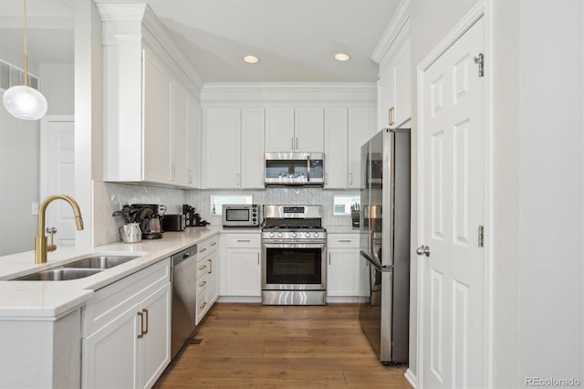 3178 Geneva Ct, Denver, CO 80238 - kitchen with appliances with stainless steel finishes, a sink, white cabinetry, dark wood-style flooring, and backsplash