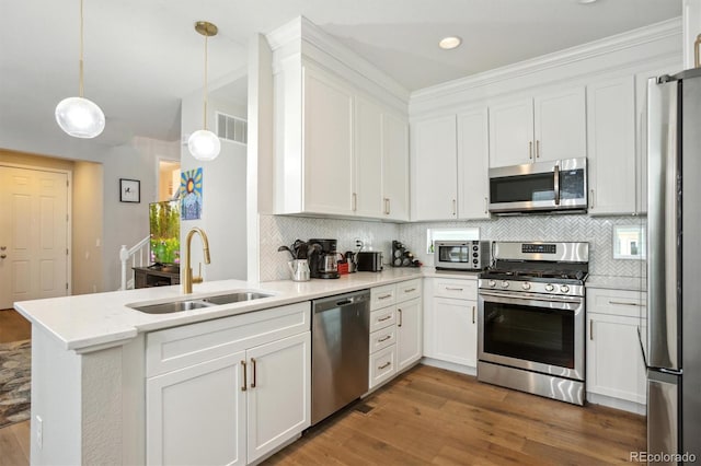 3178 Geneva Ct, Denver, CO 80238 - kitchen with stainless steel appliances, a sink, a peninsula, white cabinets, and backsplash