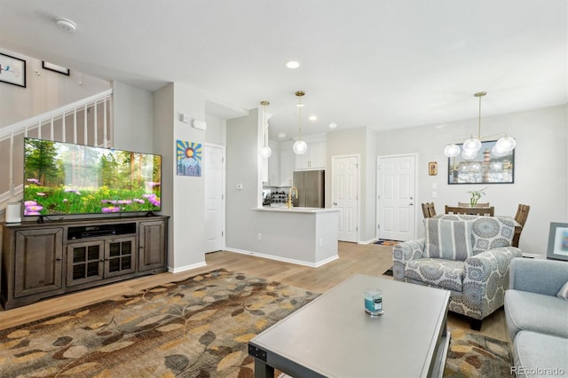 3178 Geneva Ct, Denver, CO 80238 - living area with wood finished floors, recessed lighting, baseboards, and a chandelier