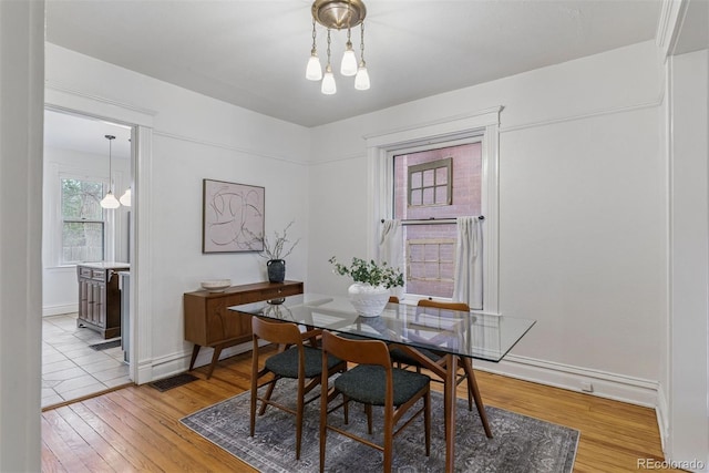 dining room featuring baseboards and light wood finished floors